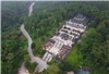 The tomb of King Khai Dinh is surrounded by green trees on the outskirts of Hue